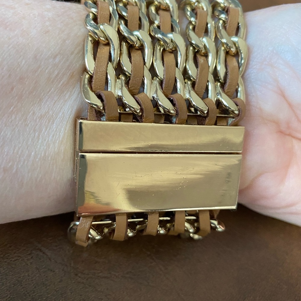 Goldtone and leather bracelet with magnetic fastener. Measures 2in wide 8in long